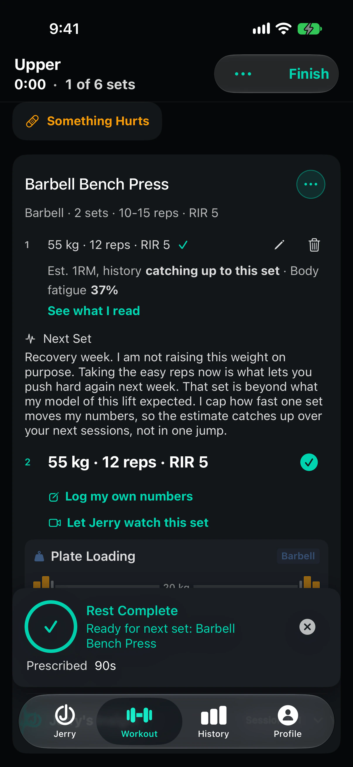 The same console after set 1 is logged. Under the logged set, a Next Set note says it is a recovery week and he is not raising the weight on purpose, that the set beat what his model of the lift expected, and that he moves his estimate over the next sessions rather than in one jump. The rest card reads Rest Complete with 90 seconds prescribed.